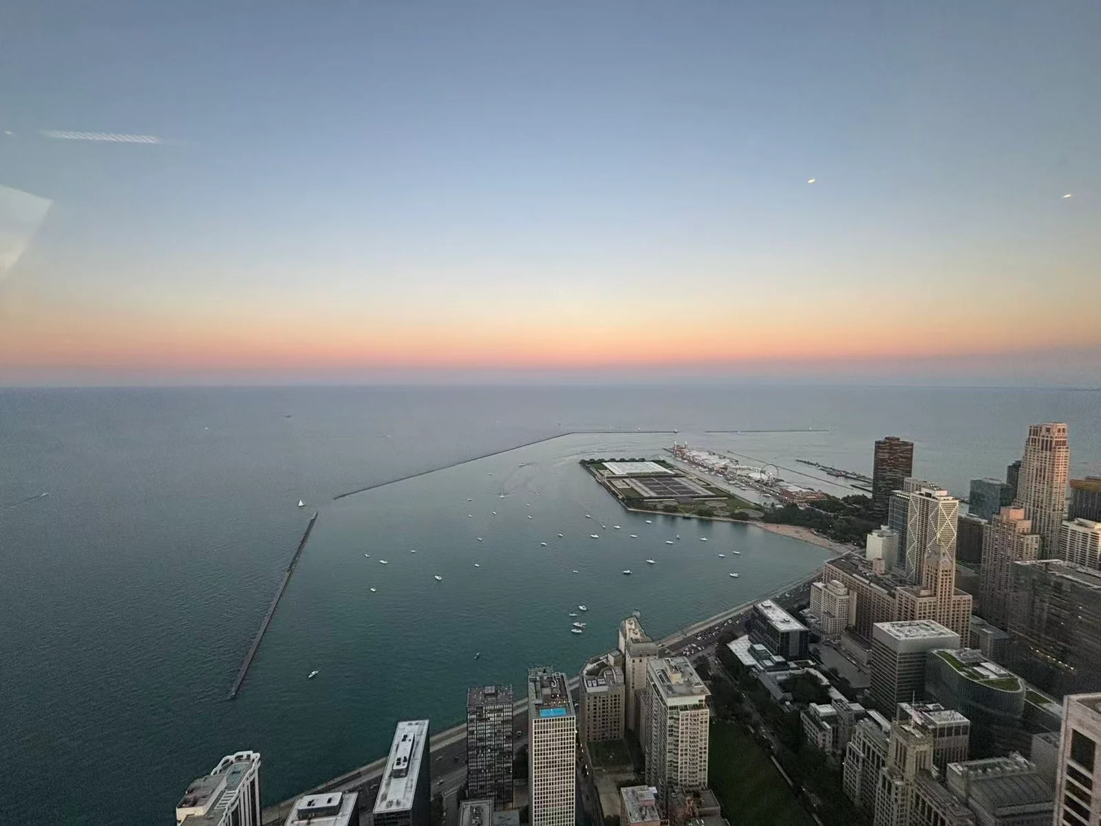 An elevated view over Lake Michigan and the Chicago shoreline at dusk
